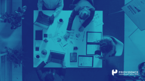 A team reviewing HR system data on a screen post-implementation