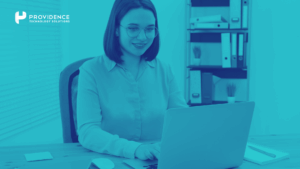 An employee engaging with a digital training platform on a laptop in a modern office.