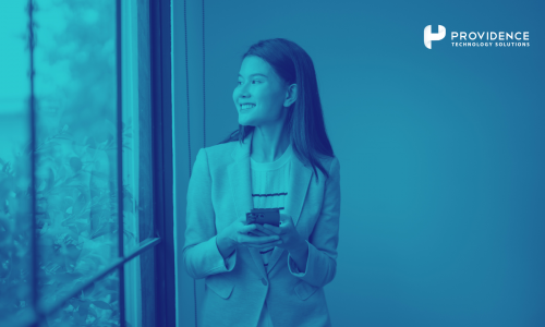 A frontline employee using a mobile phone to access HR self-service tools during a work shift.