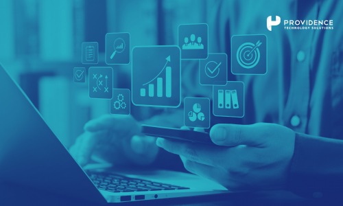 A business leader reviewing HR dashboards and cost savings metrics on a laptop with an HR manager nearby.